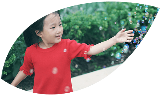 A girl playing with bubbles