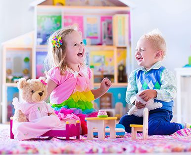 A boy and girl having a tea party.