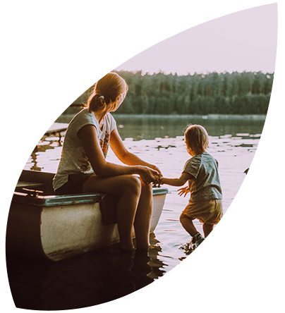 A mother and son enjoying an evening at a lake.