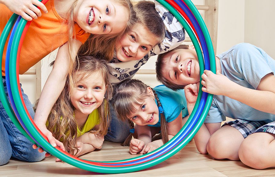 Kids playing with hula hoops.