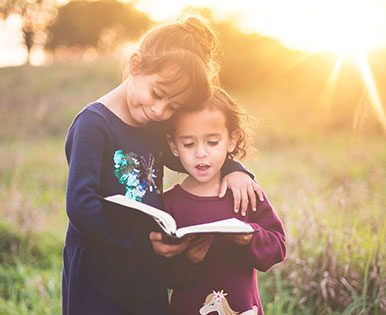 Siblings reading a book together