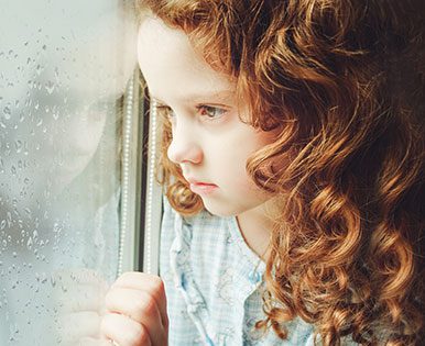 Girl looking out window