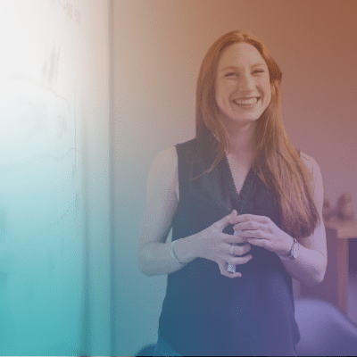 Trafficking Training - A smiling woman holding a dry-erase marker.