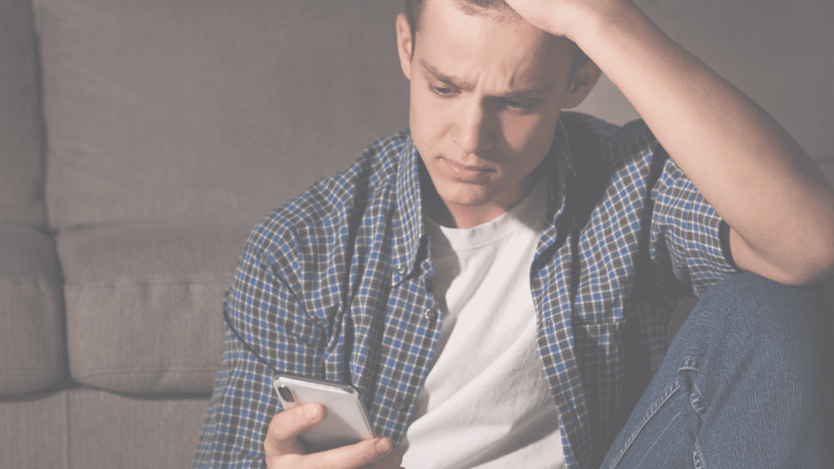 child looking frustrated at his phone.